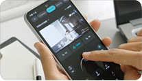 A person is holding a cell phone with a video playing.

Description generated by AI